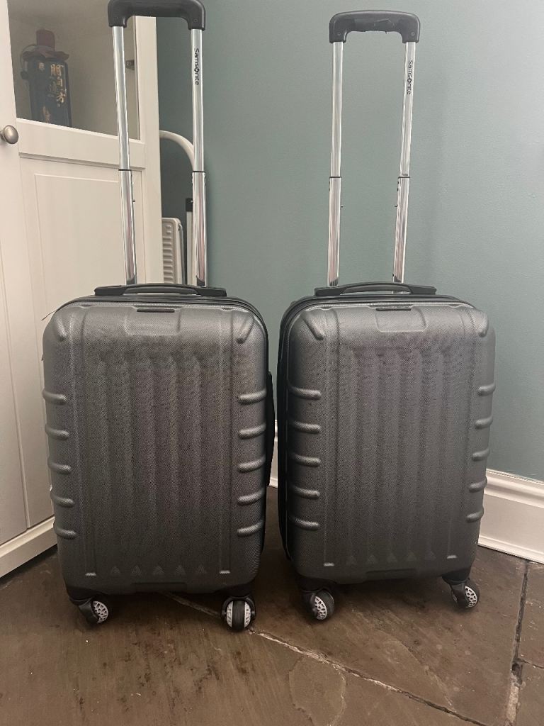 2x Grey hard shell Samsonite suitcases