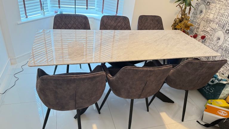 Stone table and six grey chairs for sale