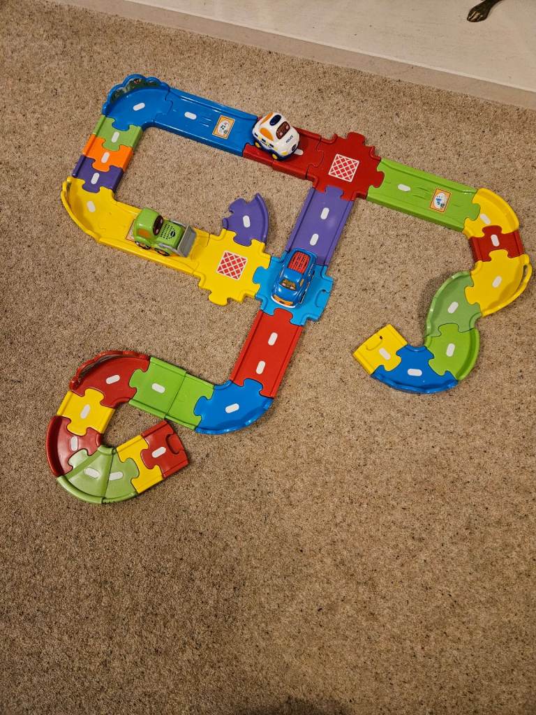 Vtech toot toot track and 3 cars. Pick up truck, bulldozer and police car.