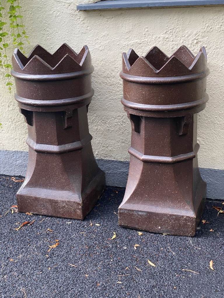 A PAIR OF MATCHING BROWN SALTGLAZED VICTORIAN CHIMNEY POTS