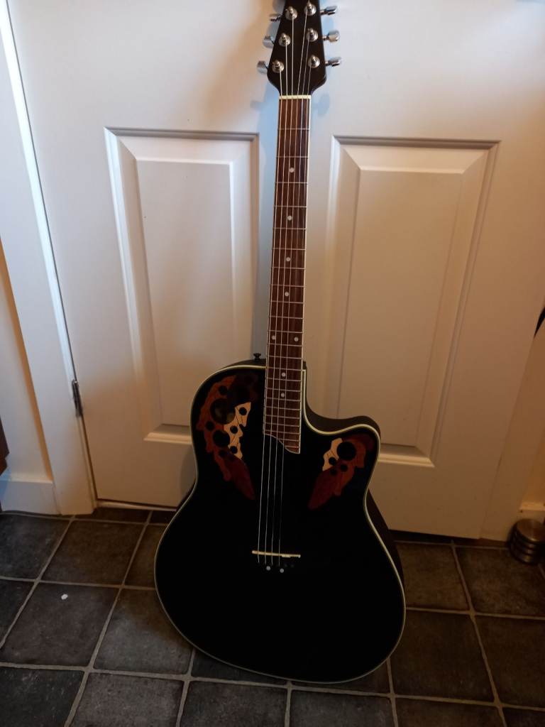 Beautiful Ovation electro-acoustic guitar with hard shell case.
