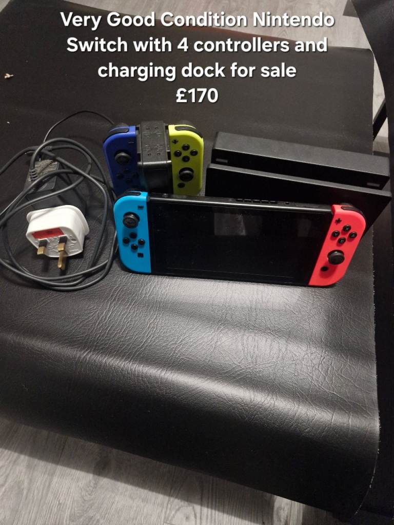 Nintendo Switch with 4 controllers and charging dock