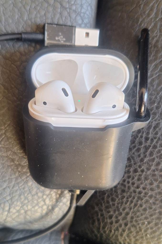 Airpods white with charging case and black protective clip on black case