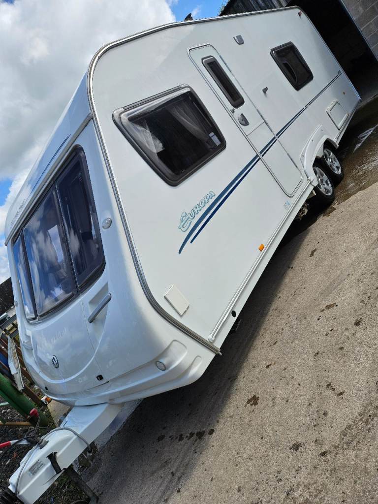 Four berth, fixed single beds touring caravan with motor mover, awning & accessories 