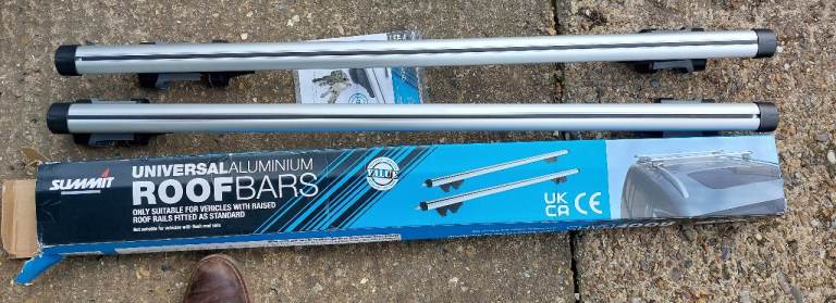 Roof bars for vehicles with raised rails