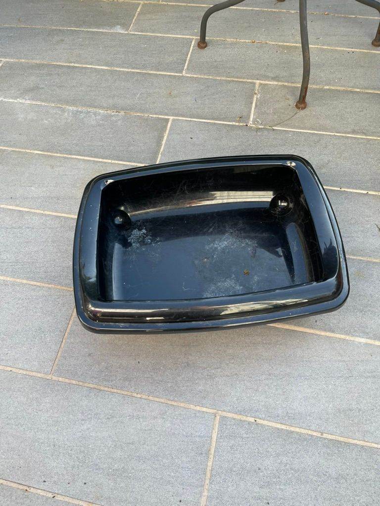 Black plastic cat litter tray