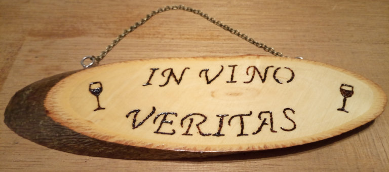 Handmade hanging decorative wooden wall plaque with Pyrography text-'In wine lies truth'