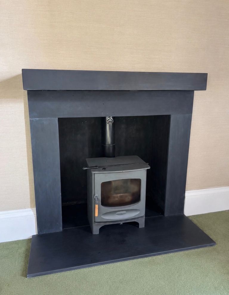 Wood burning stove with slate fireplace surround