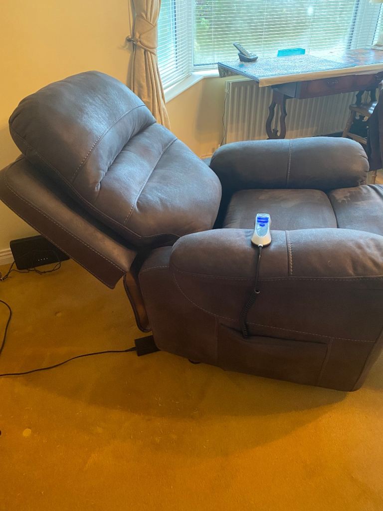 Electric rise and fall armchair in dark grey. 