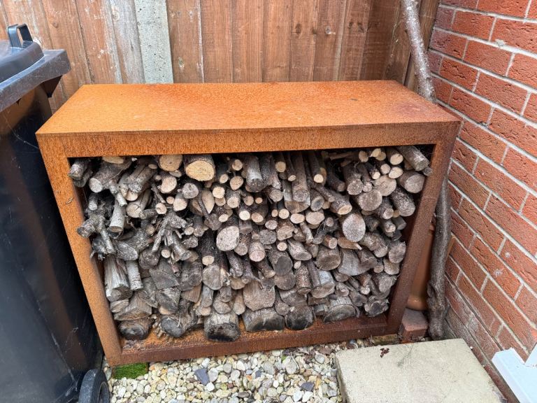 Log firewood storage rack in steel with natural rust effect