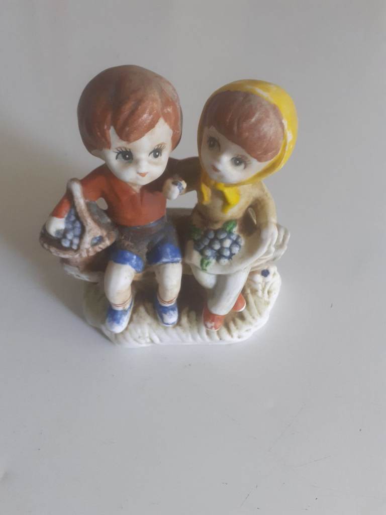 Vintage porcelain boy and girl on bench figurine 