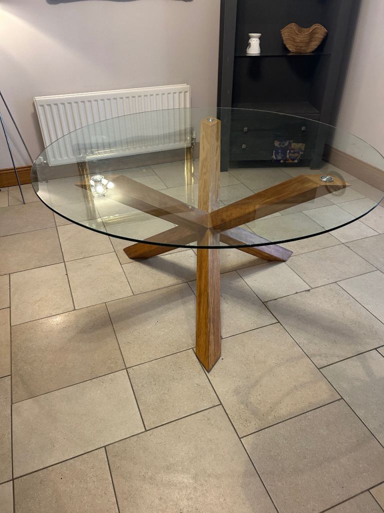 Oak round dining table seats six. Glass top.