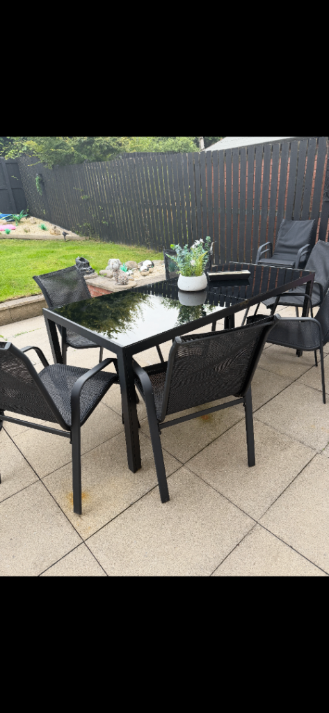 Garden furniture- black glass table and 6 chairs free standing parasol 1 year old ex condition 