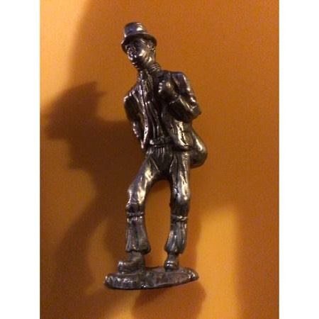 Silver plated miniature figure of traveller with bag 