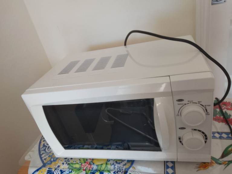 Microwave - white - its in good to fair condition. It has been used a lot. Manual dial Microwave.