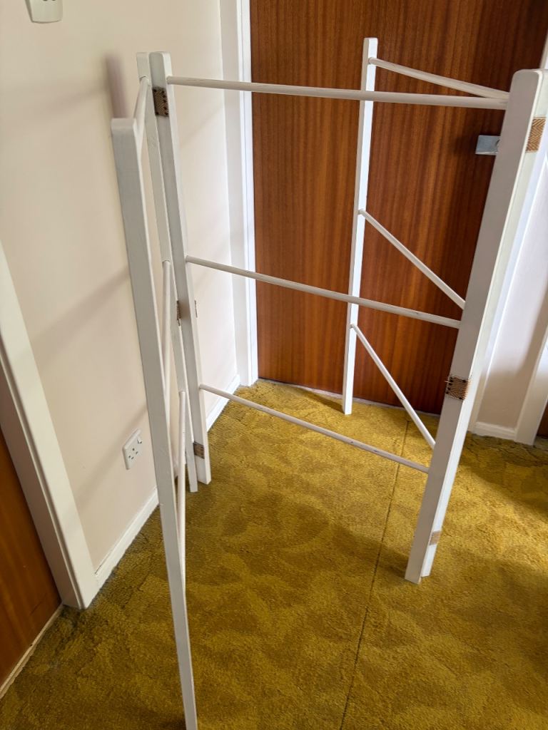 White wooden clothes drying rails