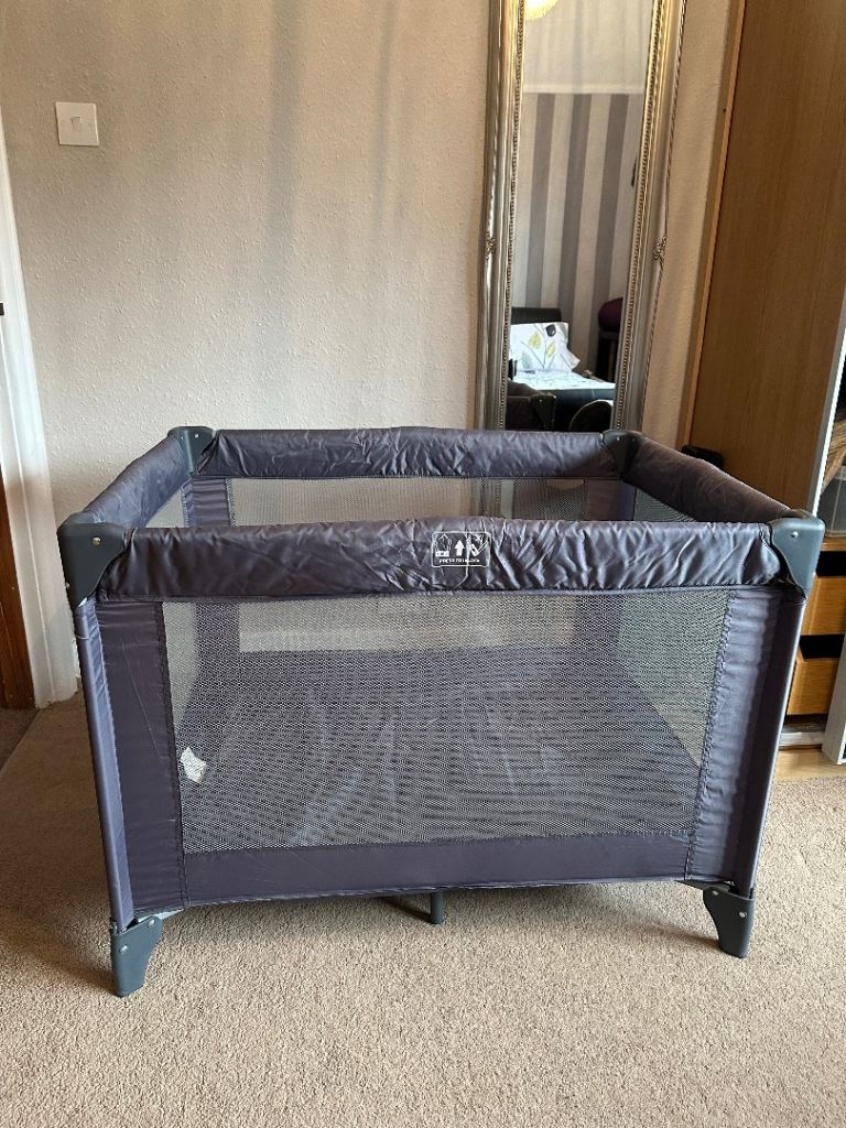 Grey travel cot 
