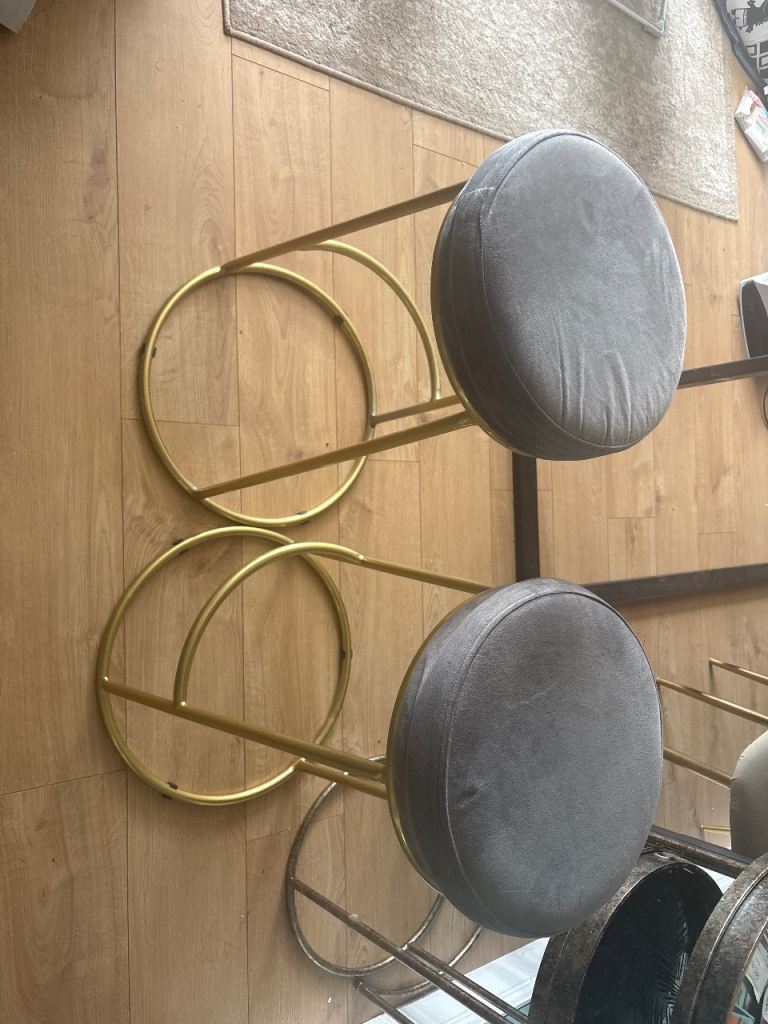 2 grey and gold bar stools