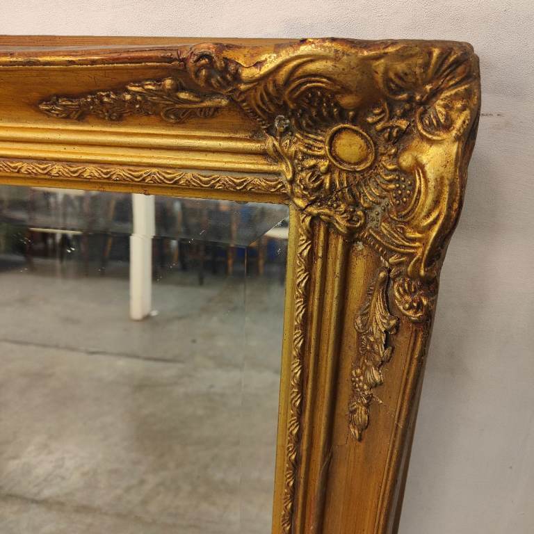 A large Victorian style gilt mirror.
