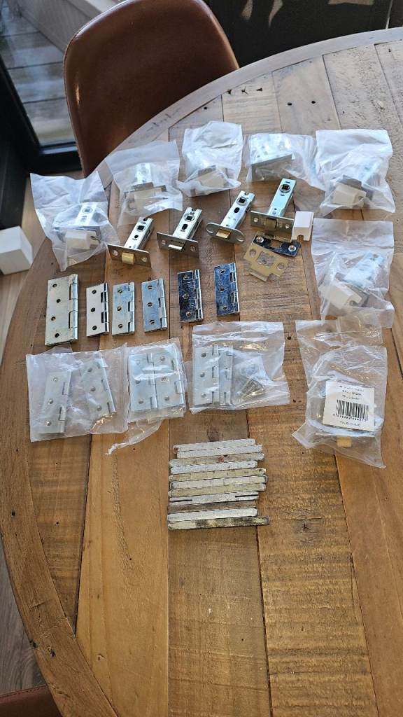 A selection of hinges, latch packs, most still sealed, as per photo.