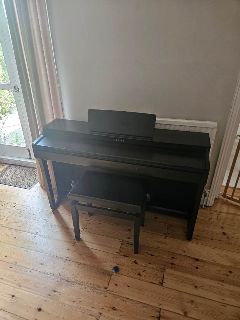 Yamaha Clavinova CLP-625 Piano with stool and books