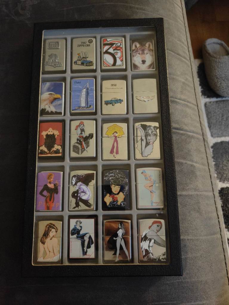 20 Zippo's in display case, some rare, some sealed