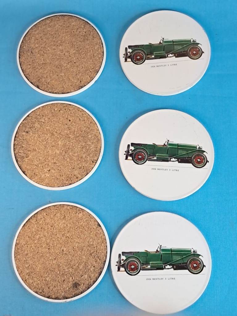 Vintage of six white, circular coasters 1926 Bentley 3 Litre car. .