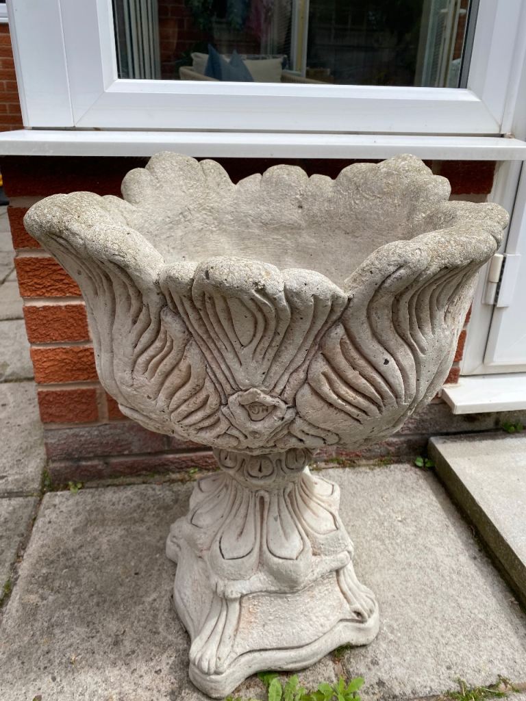 Two large tulip concrete garden planters