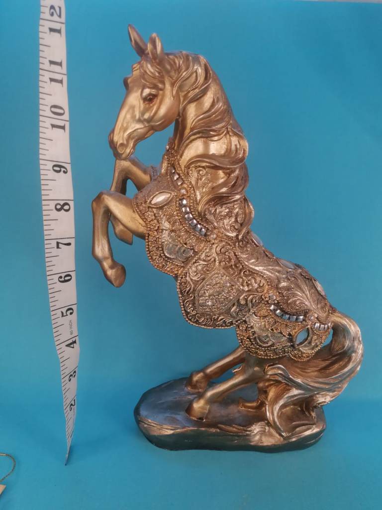 The item is a large, golden-colored horse statue,  made of polyresin. 