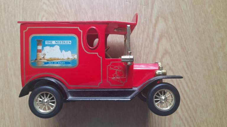Red vintage tin toy car money box
