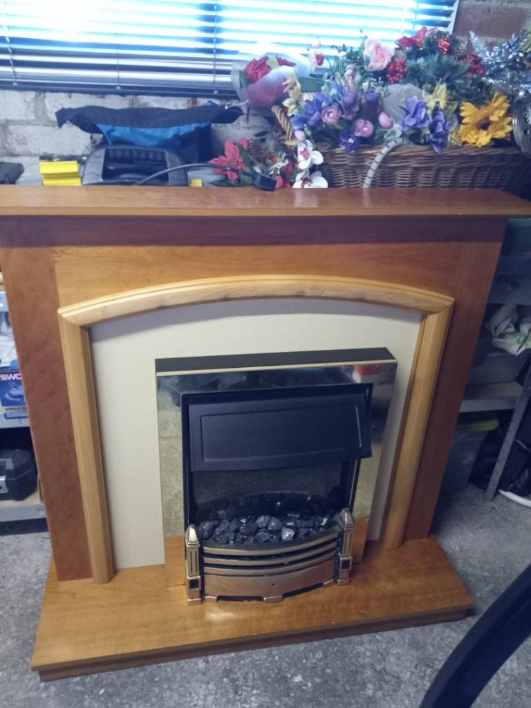 Light wood fireplace with coal effect convector electric fire
