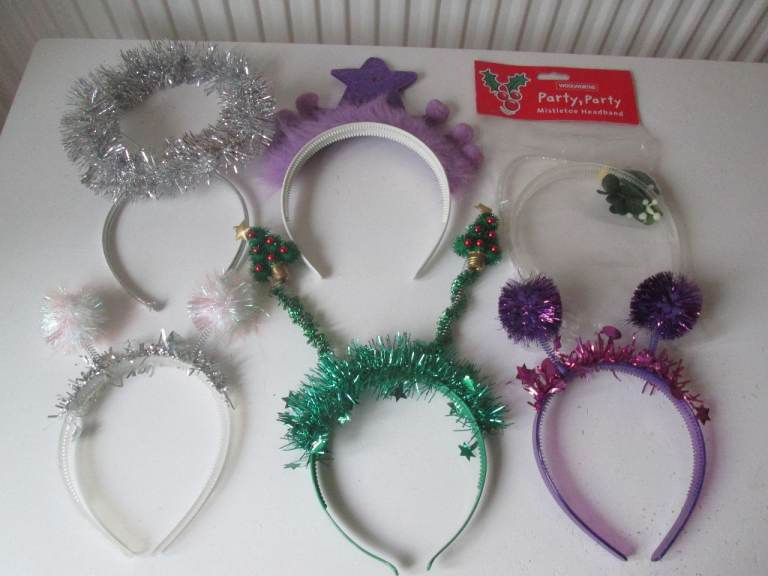 Six assorted Christmas headbands including a musical one.