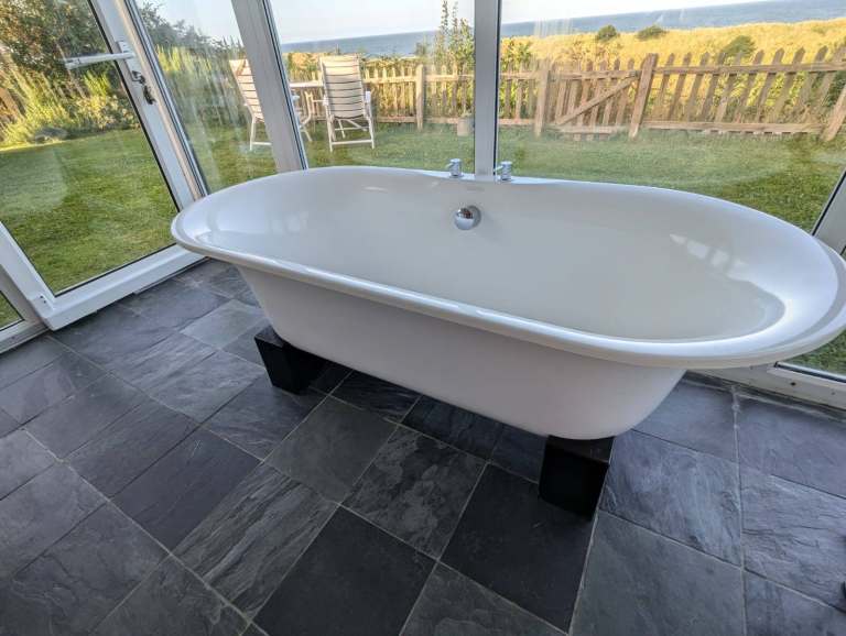 Victoria & Albert Freestanding Double Ended Roll Top Bath with black woodgrain base