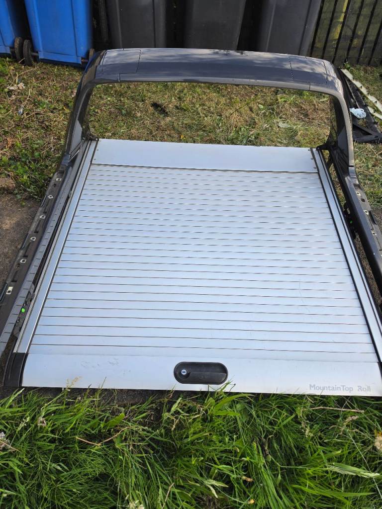 Mountaintop roller shutter and spoiler