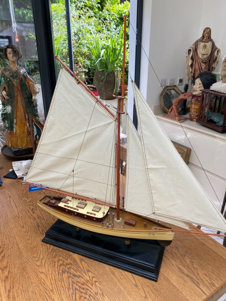 Model sailing yacht on black stand