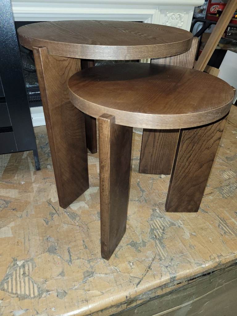 A new designer style nest of 2 dark wood finish nest of tables they are 