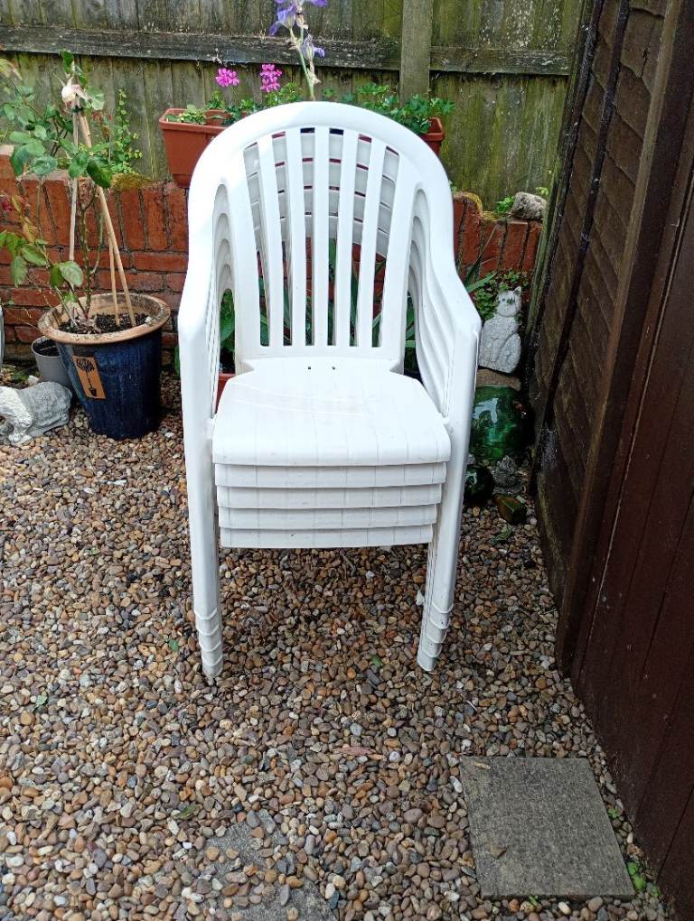 5 White plastic garden chairs