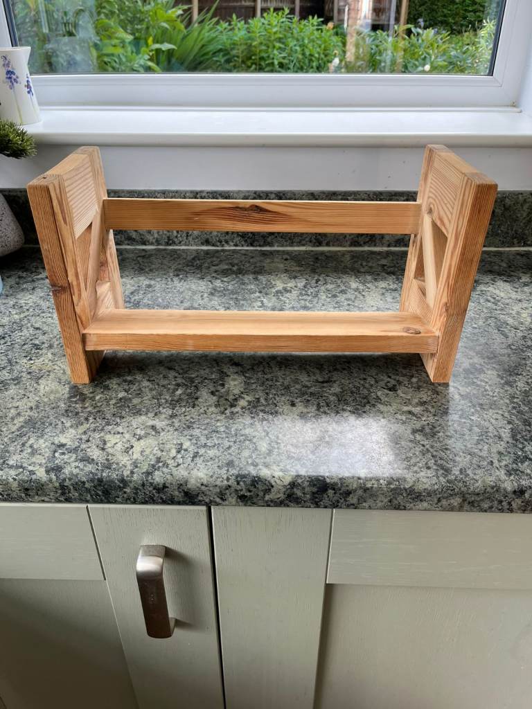 A wooden desk top book rack.