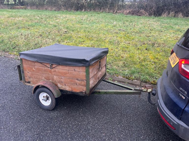 Small camping trailer with hard top and cover 