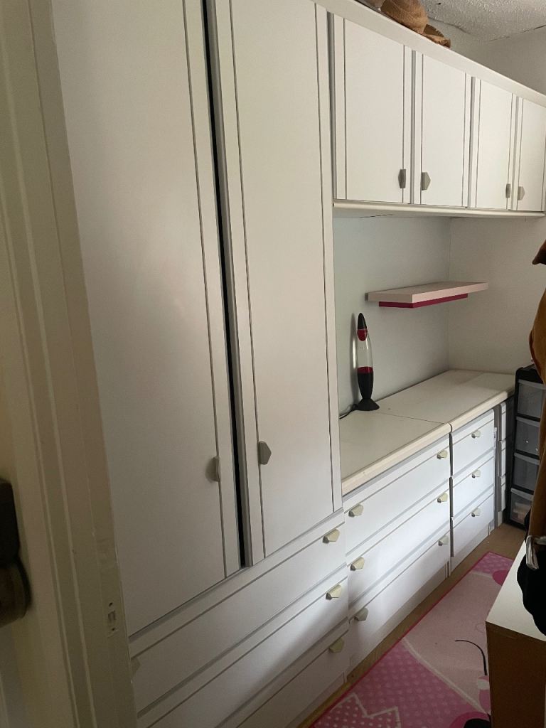 Wardrobe with overhead cupboards and drawers