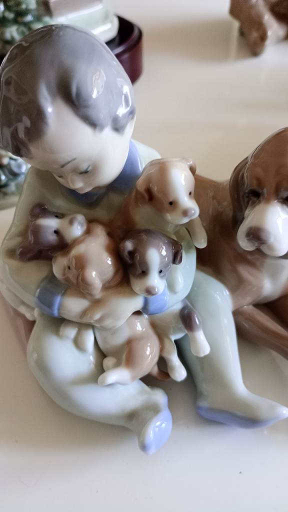 Lladro boy with dog and puppies 