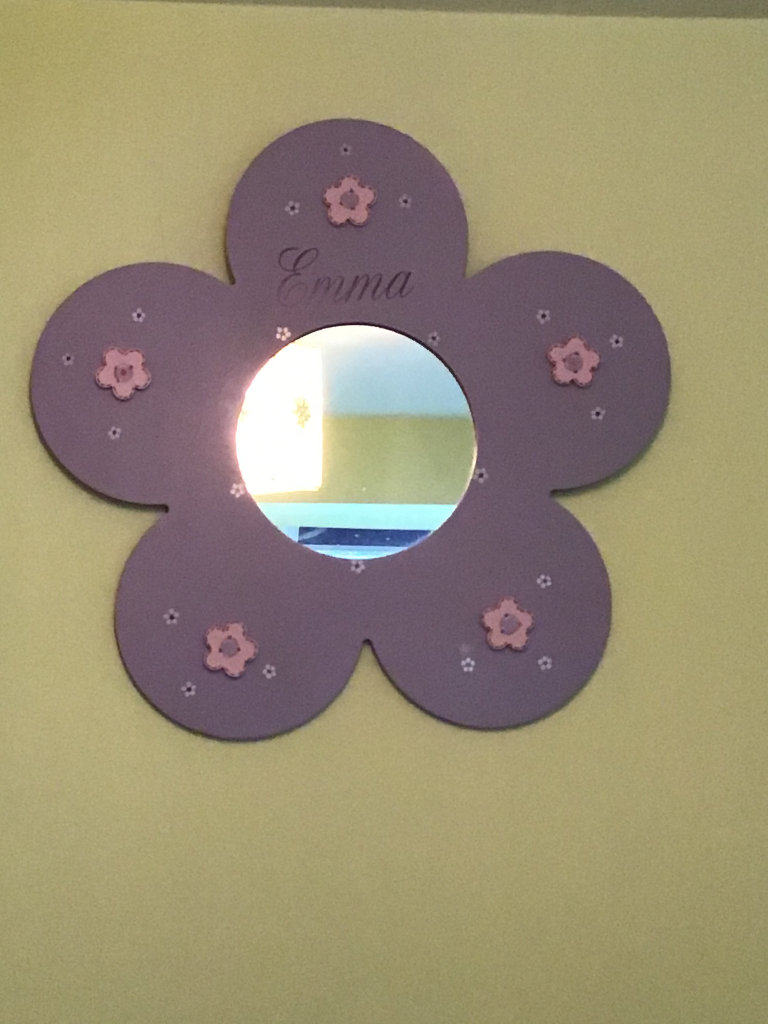 Mirror and wall pegs for clothes all marked with the name EMMA 