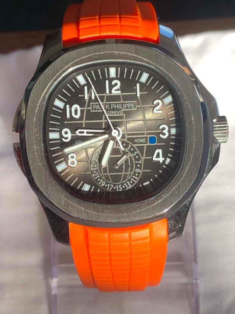 Nautilus Aquanaut Chronograph Travel Time. Automatic, with Orange Rubber Strap. NEW, UNWORN