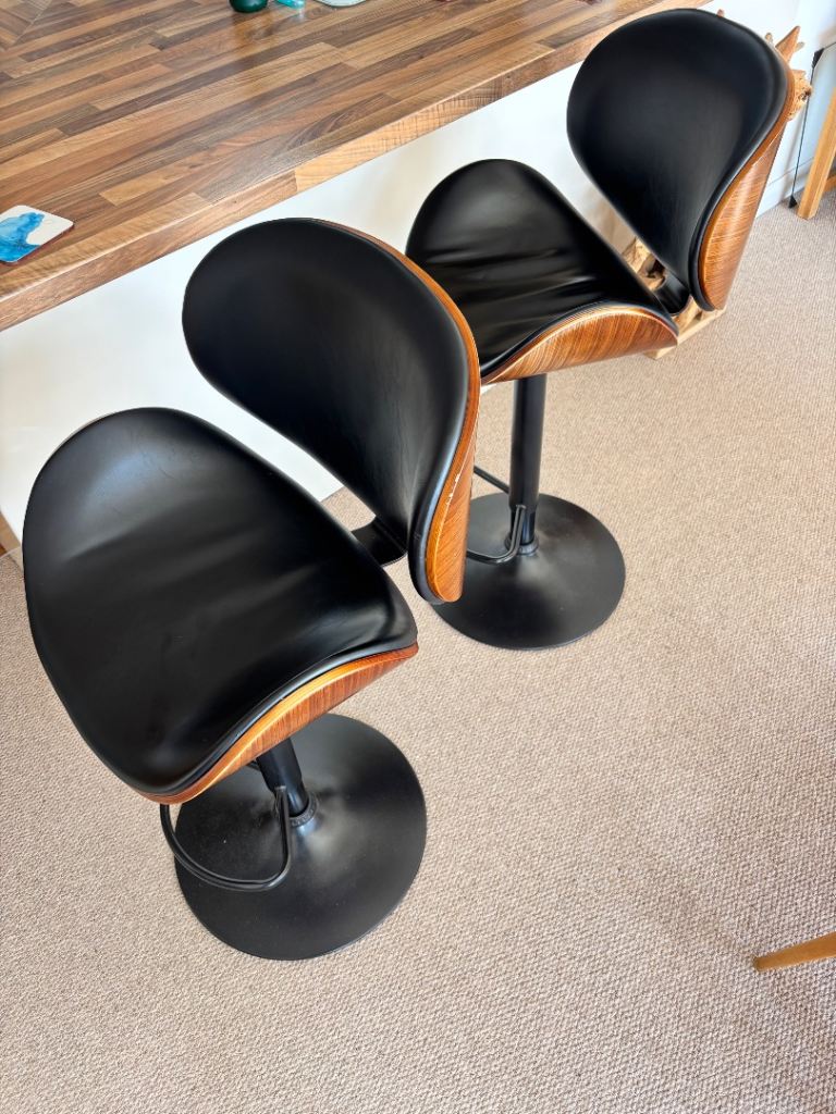 2 Faux leather swivel bar stools. 
