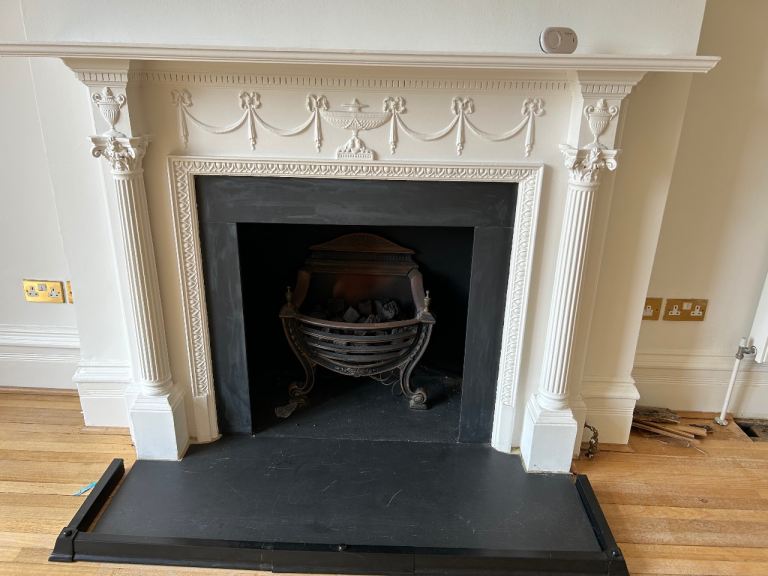 Neoclassical fireplace with hearth & cast iron fire basket 