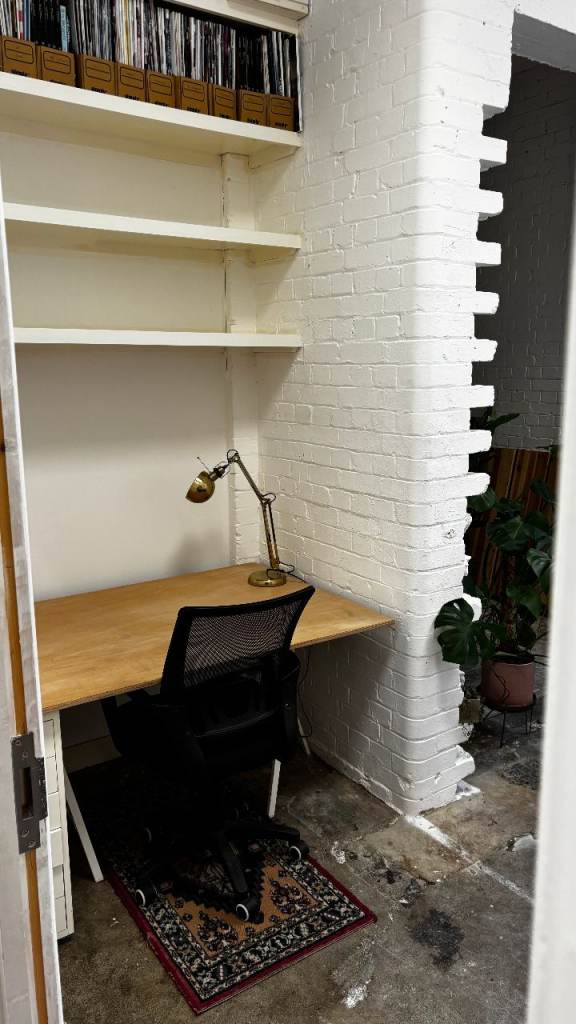 Shared office with large desk and big windows
