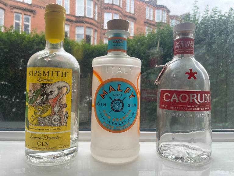 Four empty gin bottles ~ Malfy, Sipsmith, Caorunn, Gordon's