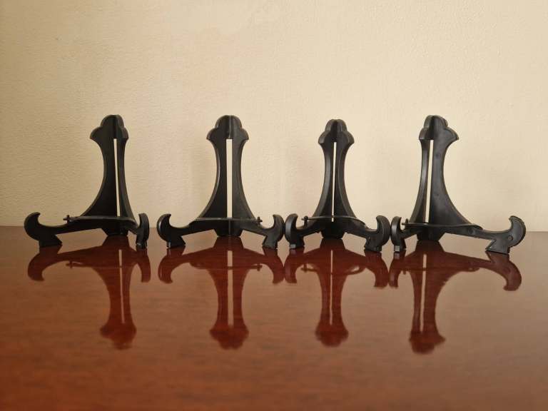 4 black plastic plate display stands /holders. 