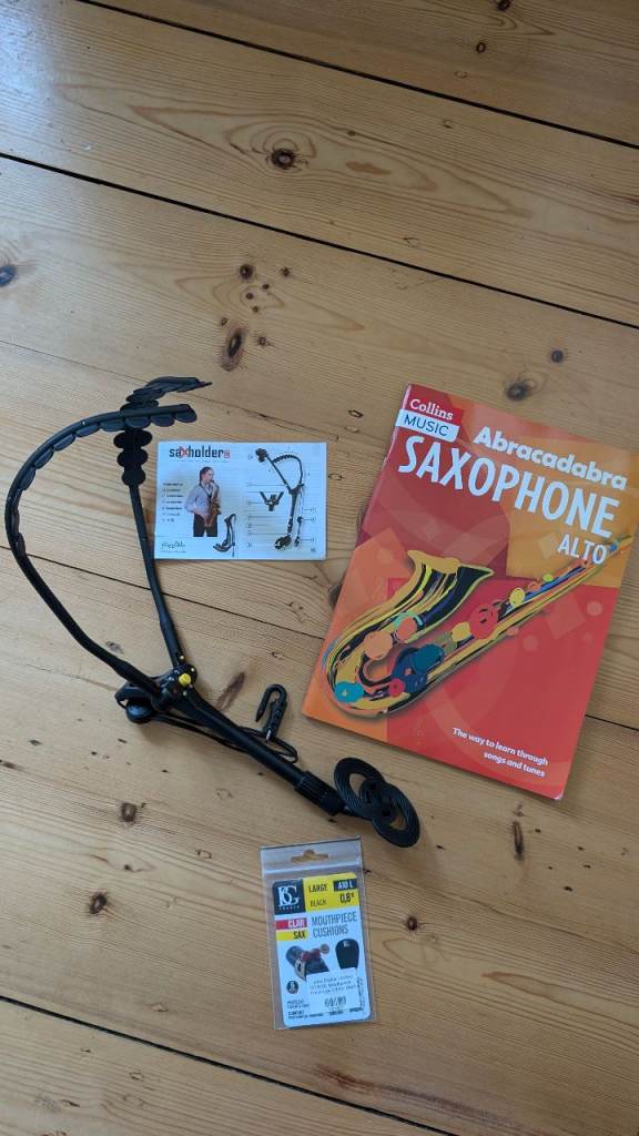 Saxophone shoulder strap, mouthpiece cushions and Abracadabra Saxophone Alto book 