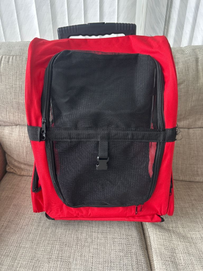 Dog or animal carrier with wheels and can also be carried on back.